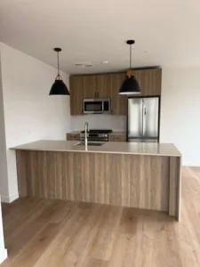 Frontal view of a kitchen island and cabinetry within a completed modern Norwalk home renovation.