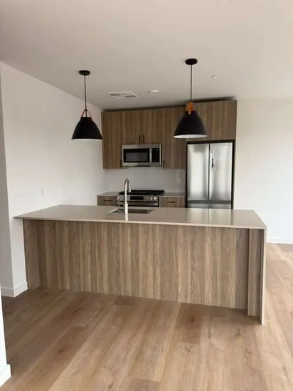 Frontal view of a kitchen island and cabinetry within a completed modern Norwalk home renovation.
