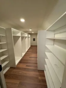Hallway perspective showing finished shelving units on both sides, highlighting the completed closet installation Wethersfield CT.