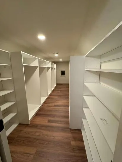 Hallway perspective showing finished shelving units on both sides, highlighting the completed closet installation Wethersfield CT.